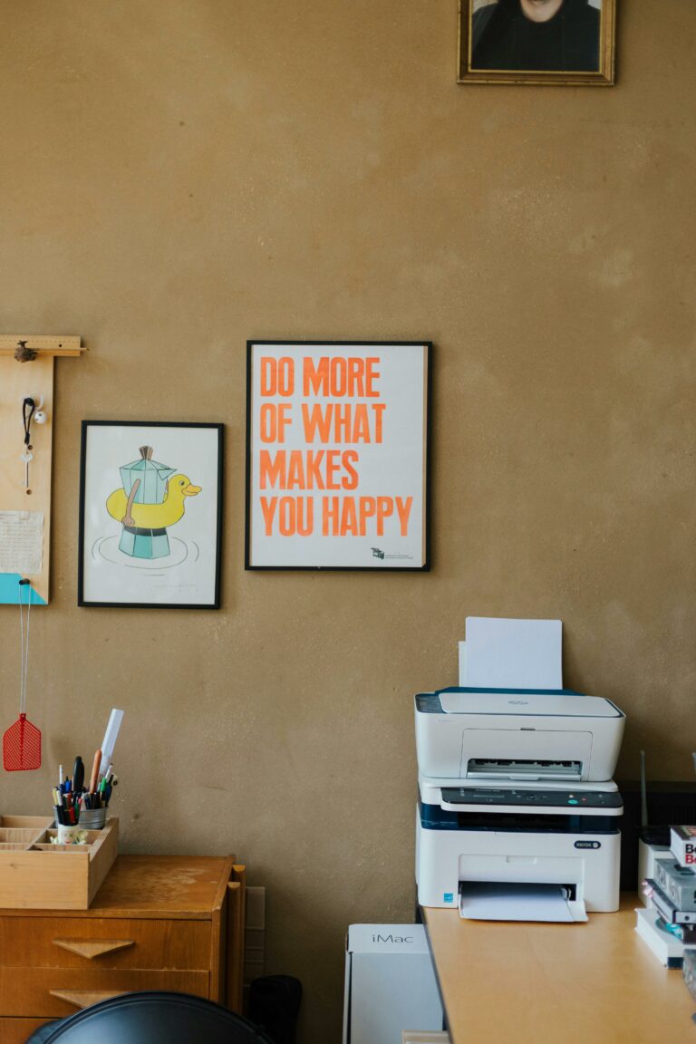 Office corner with motivational posters and printer for a positive workspace vibe.